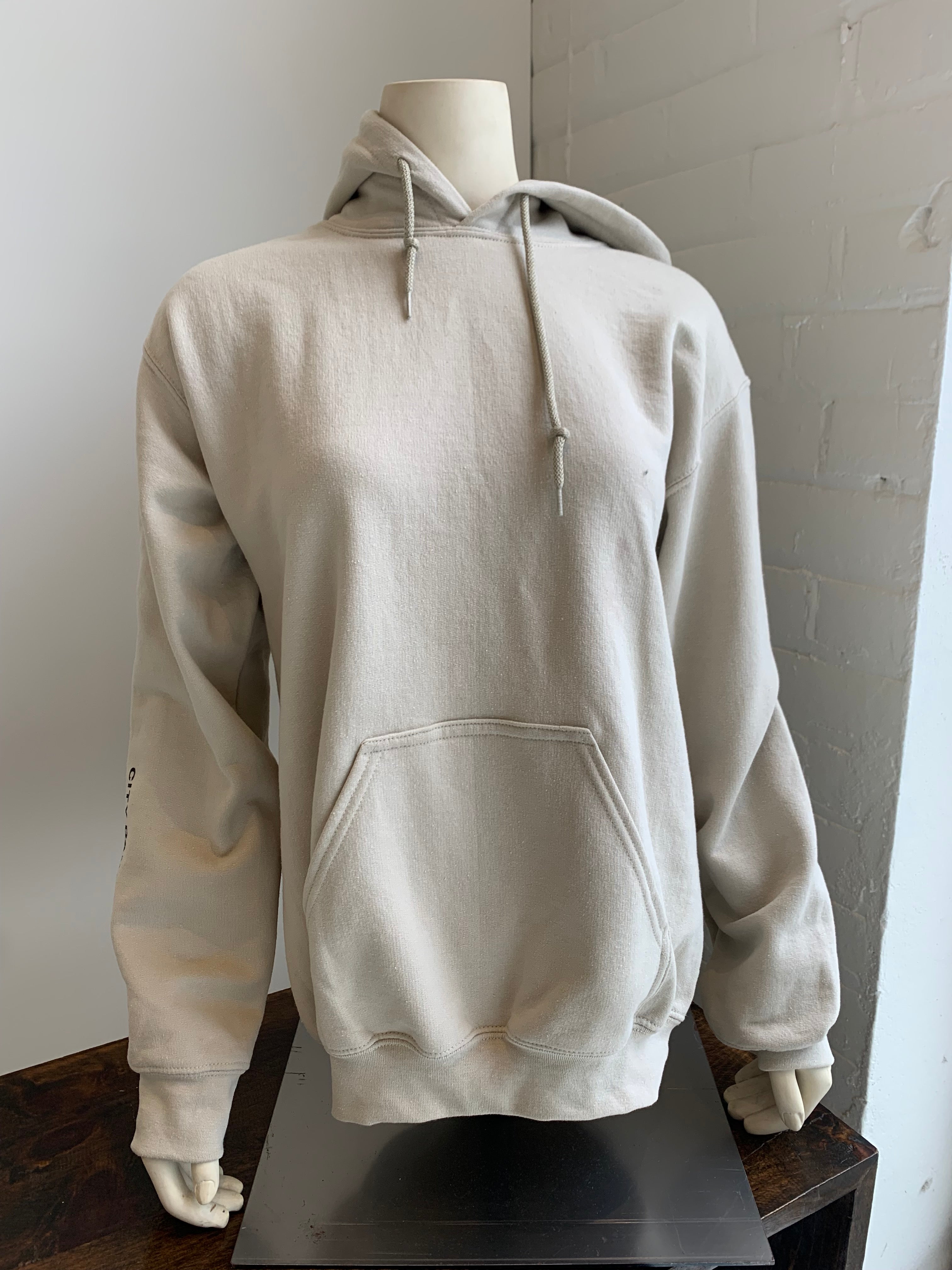 Beige hoody for dancers for warm up and cool down. Dance More Live More logo.