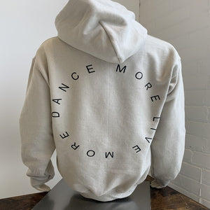 Beige hoody for dancers for warm up and cool down. Dance More Live More logo.